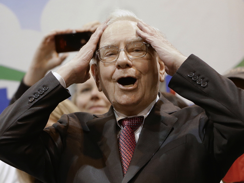 Berkshire Hathaway Chairman and CEO Warren Buffett  reacts at the newspaper throwing competition while touring the exhibition floor prior to the annual shareholders meeting on Saturday, May 3, 2014, in Omaha, Neb. More than 30,000 shareholders are expected to fill the CenturyLink Arena to hear Buffett and Berkshire Vice Chairman Charlie Munger discuss their business. (AP Photo/Nati Harnik)